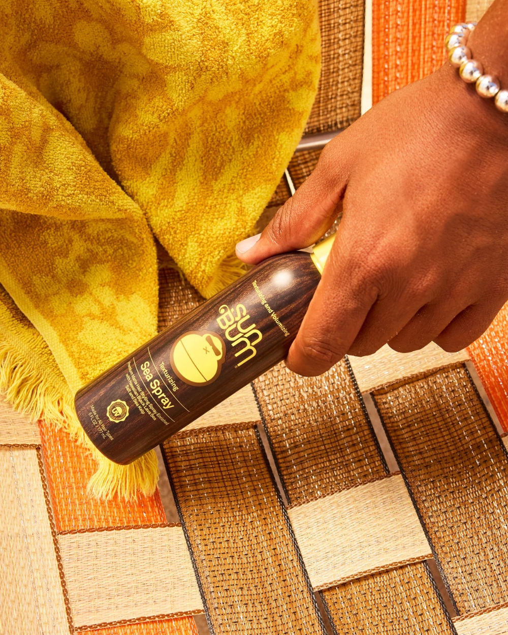 Sun Bum Sea Salt Spray 177ml displayed outdoors in a beach-inspired lifestyle scene